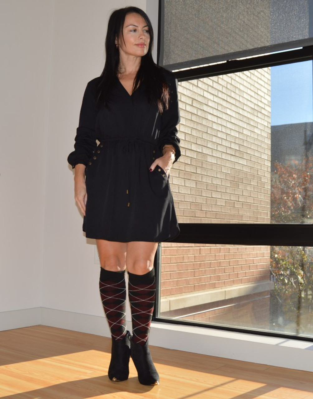 Stylish outfit with black dress and maroon tartan socks